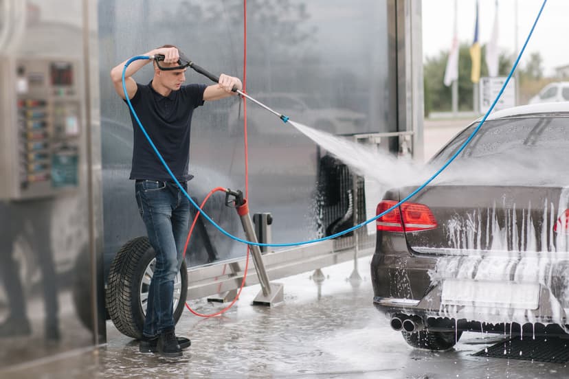 Team member washing a car