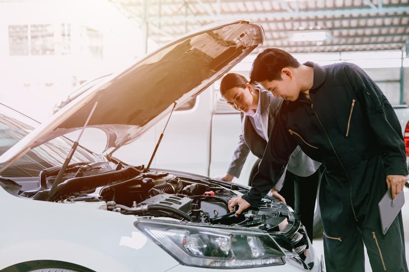 Team members checking car engine